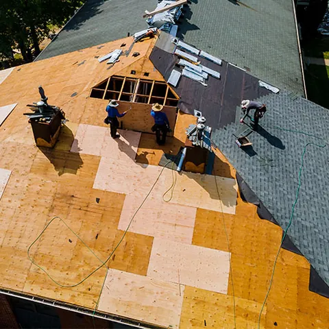 Roof deck exposed during a tear-off, with new plywood going down