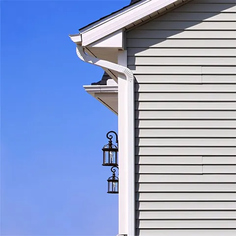 White downspout on gray siding
