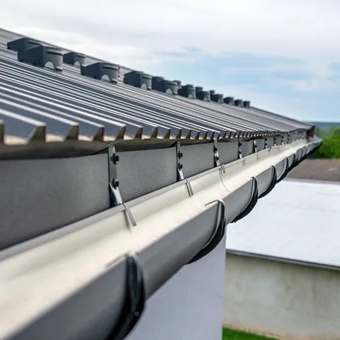 Metal gutter run along a roof edge