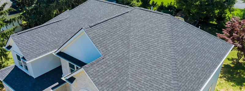 Aerial view of a gray shingle roof with a dormer