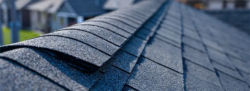 Close view of an asphalt shingle roof ridge
