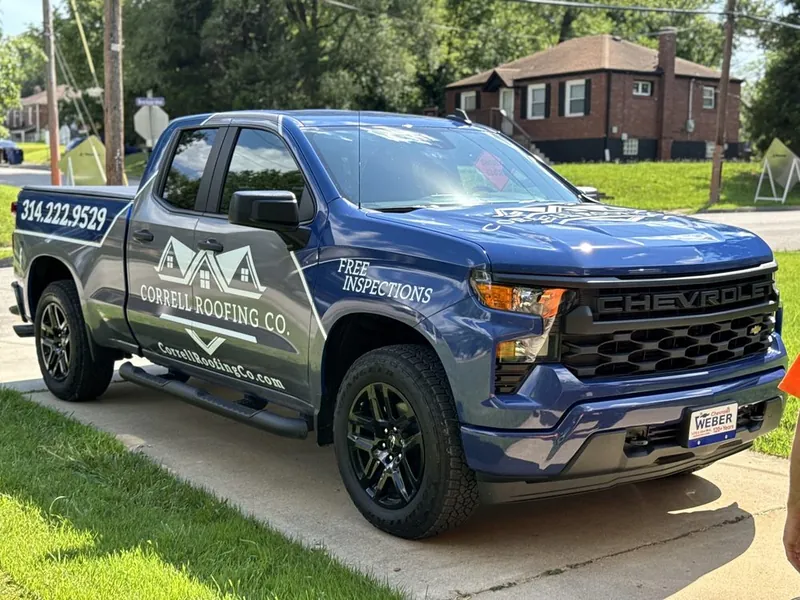 Wrapped Correll Roofing Silverado parked on a residential street